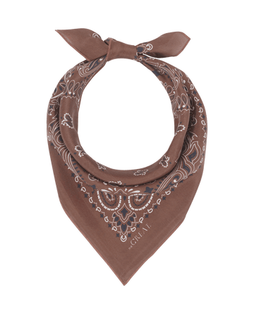 The Silk Bandana in Chocolate by THE GREAT. F25 COLLECTORS features a white paisley pattern, folded and tied loosely into a triangular shape.