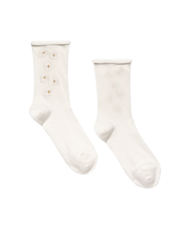 THE GREAT. SP25 POINTELLE SOCKS: The Pointelle Sock in true white features delicate daisy embroidery on one sock, while the other remains plain for subtle charm.