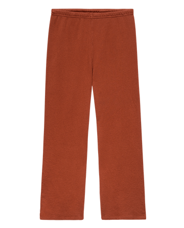 The Lap Sweatpant. Solid -- Brick by THE GREAT. F25 SEASONAL KNITS: rust-colored, wide cropped sweatpants with an elastic waistband, handcrafted in Los Angeles for comfort and style, shown laid flat on a white background.