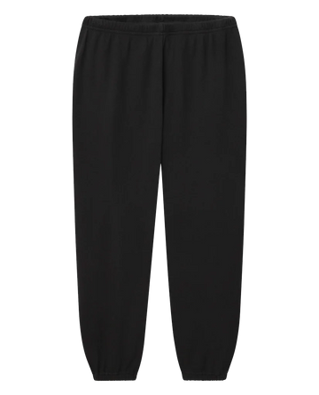 A pair of The Stadium Sweatpant. Solid in Almost Black by THE GREAT. CORE KNITS, featuring an elastic waistband and elastic cuffs at the ankles, perfect for achieving a vintage athletic look.