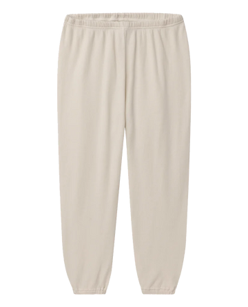 A pair of washed white Stadium sweatpants featuring an elastic waist and elastic cuffs at the ankles, made from 100% cotton and highlighted against a white background. This piece is part of THE GREAT. CORE KNITS collection.