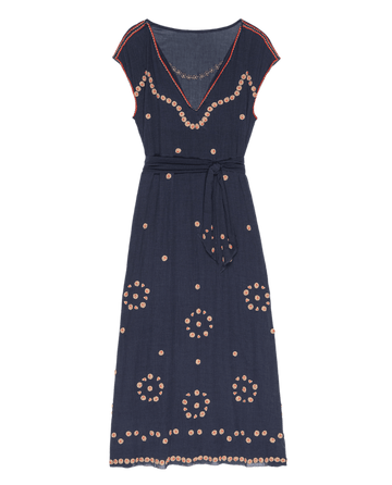 The Beaded Corridor Dress by THE GREAT. SU25 features a navy blue color, cap sleeves, V-neckline, belted waist, and light pink circular embroidery throughout.