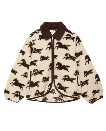 The Pasture Jacket by THE GREAT. F25 D2 features a cream with hickory horse pattern, zipper closure, and contrasting brown collar, cuffs, and hem—a cozy plush zip-up perfect for outdoor adventures.