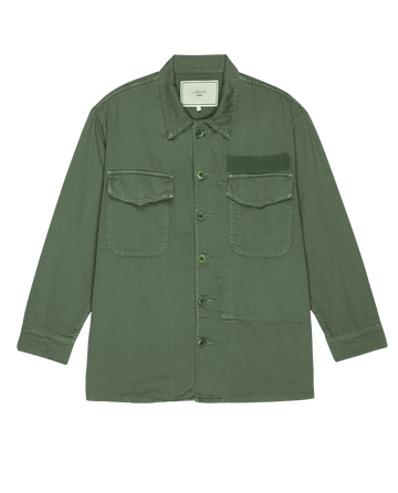 Olive green button-up shirt by THE GREAT. SP25 COLLECTORS, crafted from cotton slub twill with two chest pockets and long sleeves, offers a stylish nod to The Vintage Army Jacket.