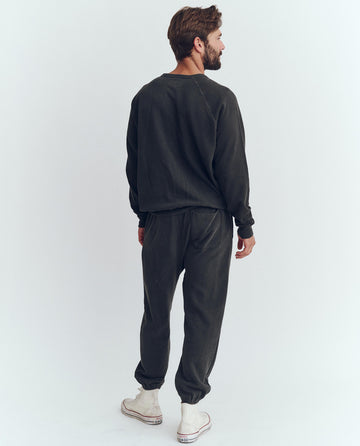 The Men's College Sweatshirt. Graphic -- Washed Black with Polar Bear Graphic SWEATSHIRTS THE GREAT. HOL 23 D1 MEN
