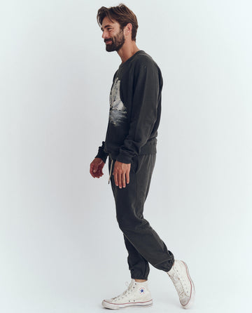 The Men's College Sweatshirt. Graphic -- Washed Black with Polar Bear Graphic SWEATSHIRTS THE GREAT. HOL 23 D1 MEN