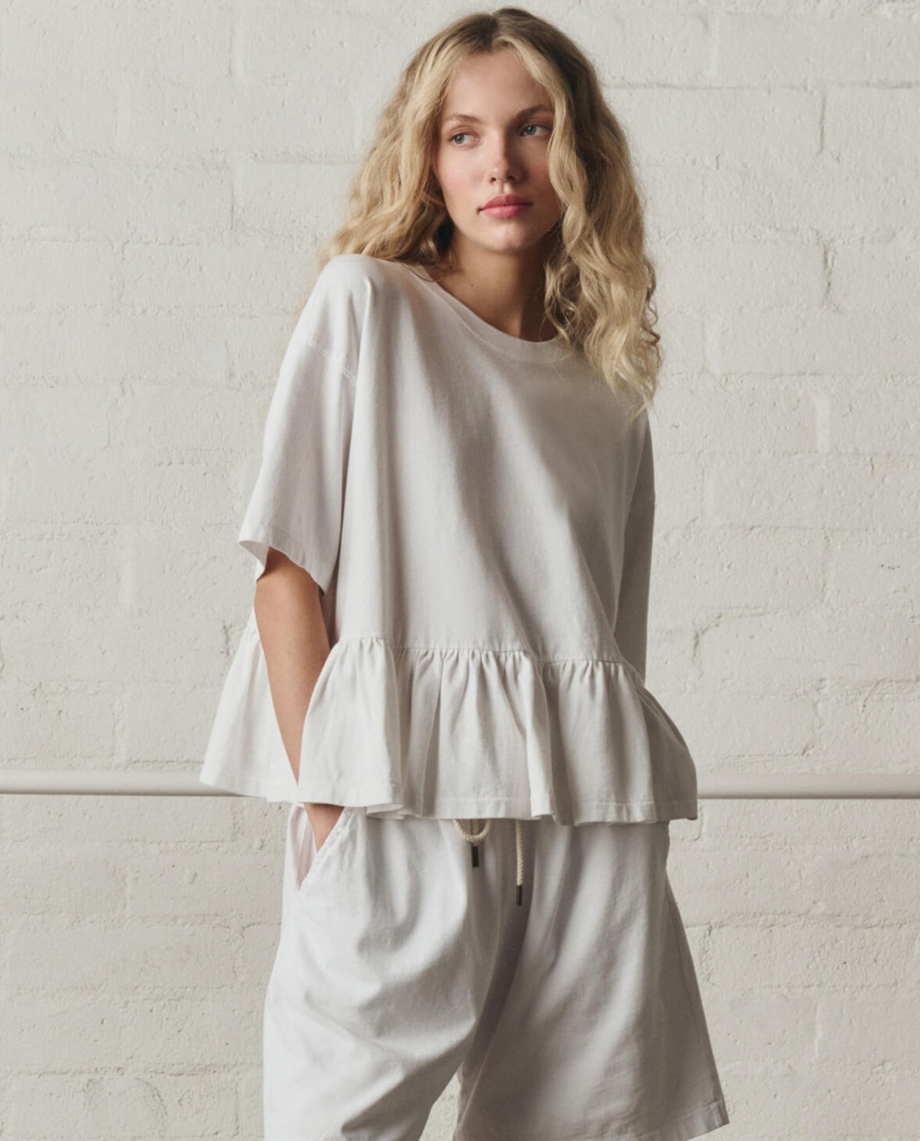The Oversized Ruffle Peplum Tee. -- True White – The Great.