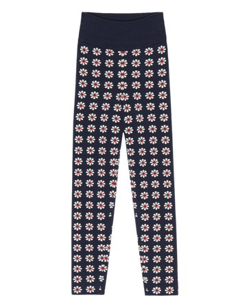 The Merino Legging – Frosted Daisy by THE GREAT. F25 TGO: Navy blue slim leggings with a white and red floral print and a wide elastic waistband—your ideal slopeside companion.