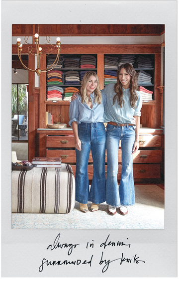 Two women in denim outfits stand smiling in front of shelves filled with folded clothing. Handwritten text reads, "always in denim surrounded by knits.