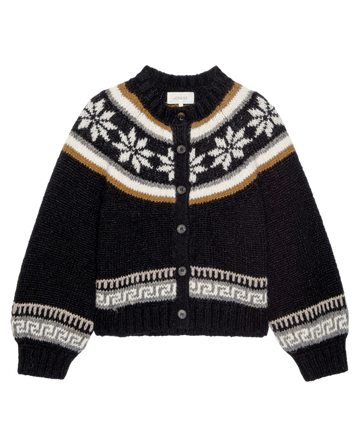 The Snowflake Ice Rink Cardigan in black by THE GREAT. H25 COLLECTION features white and tan geometric snowflake patterns, button front closure, and ribbed cuffs and hem—ideal for cozy winter wear.