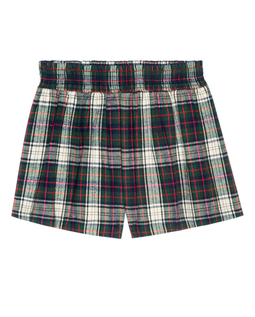 THE GREAT. H25 SLEEP The Flannel Smocked Sleep Short in Pine Lodge Plaid features a green, red, and white plaid design with an elastic waistband, shown flat on white—ideal for cozy women's sleepwear.