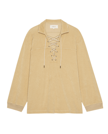 The Micro Terry Lace Up Tunic in chamois by THE GREAT. SU25 MICRO TERRY features long sleeves, a collar, white drawstrings at the lace-up front, and a straight hem.