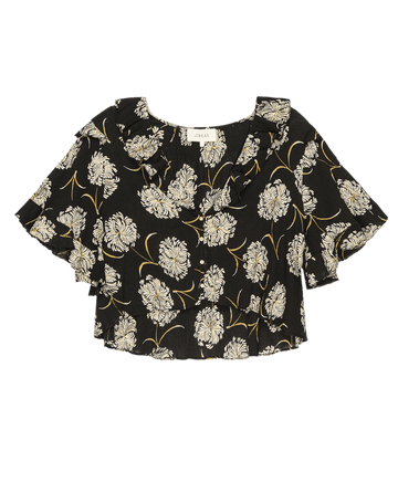 The Bower Top by THE GREAT. SU25 features a black “Dancing Floral” print, ruffled neckline, and short sleeves—a chic choice for timeless elegance, shown on a plain background.