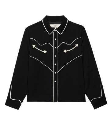 The Western Shirt by THE GREAT. F25 COLLECTORS in black with cream features long sleeves, pearl snaps, white piping, and embroidered arrow designs on the front and sleeves, shown against a plain white background.