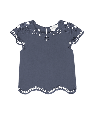 The Super Bloom Eyelet Top by THE GREAT. SU25 in vintage blue features floral cutout details, scalloped hems, and a back button closure—perfect for a standout super bloom look.