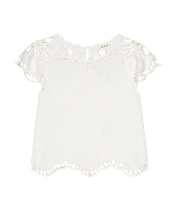 The Super Bloom Eyelet Top by THE GREAT. SU25—white short-sleeve blouse with scalloped hem and sleeves, plus floral eyelet cutouts at the neckline and edges for a fresh, feminine look.