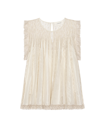 The Keepsake Lace Shell Top in cream from THE GREAT. H25 COLLECTION features sleeveless lace, pleated details, ruffled edges, and a round neckline, shown against a plain white background.