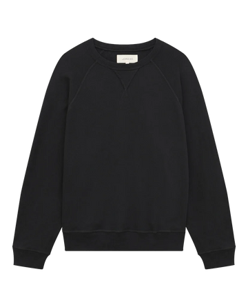 The Slouch Sweatshirt in Solid -- Almost Black by THE GREAT. CORE KNITS features a crew neck with long sleeves and ribbed cuffs, hem, and neckline. Its simple and plain design gives off a vintage sweatshirt vibe, made from 100% cotton for added comfort.