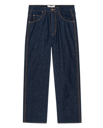 The Workwear Jean in Rinse by THE GREAT. PS25 features a classic five-pocket design and button closure, displayed on a black background.