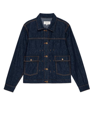 The Workwear Jean Jacket - Rinse by THE GREAT. PS25 is a classic piece featuring a button-up front, two large flap pockets on each side, and brown stitching, blending the rugged charm of workwear with everyday style.