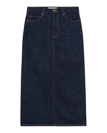 The Column Skirt in Midnight Rinse by THE GREAT. PF24 showcases a timeless column silhouette in dark denim, enhanced with a front button and zipper, two front pockets, and contrast stitching for a touch of modern flair.