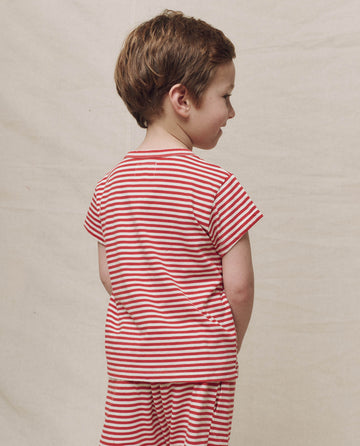 A child wearing The Little Boxy Crew in Sun Cherry Stripe faces sideways against a plain background.