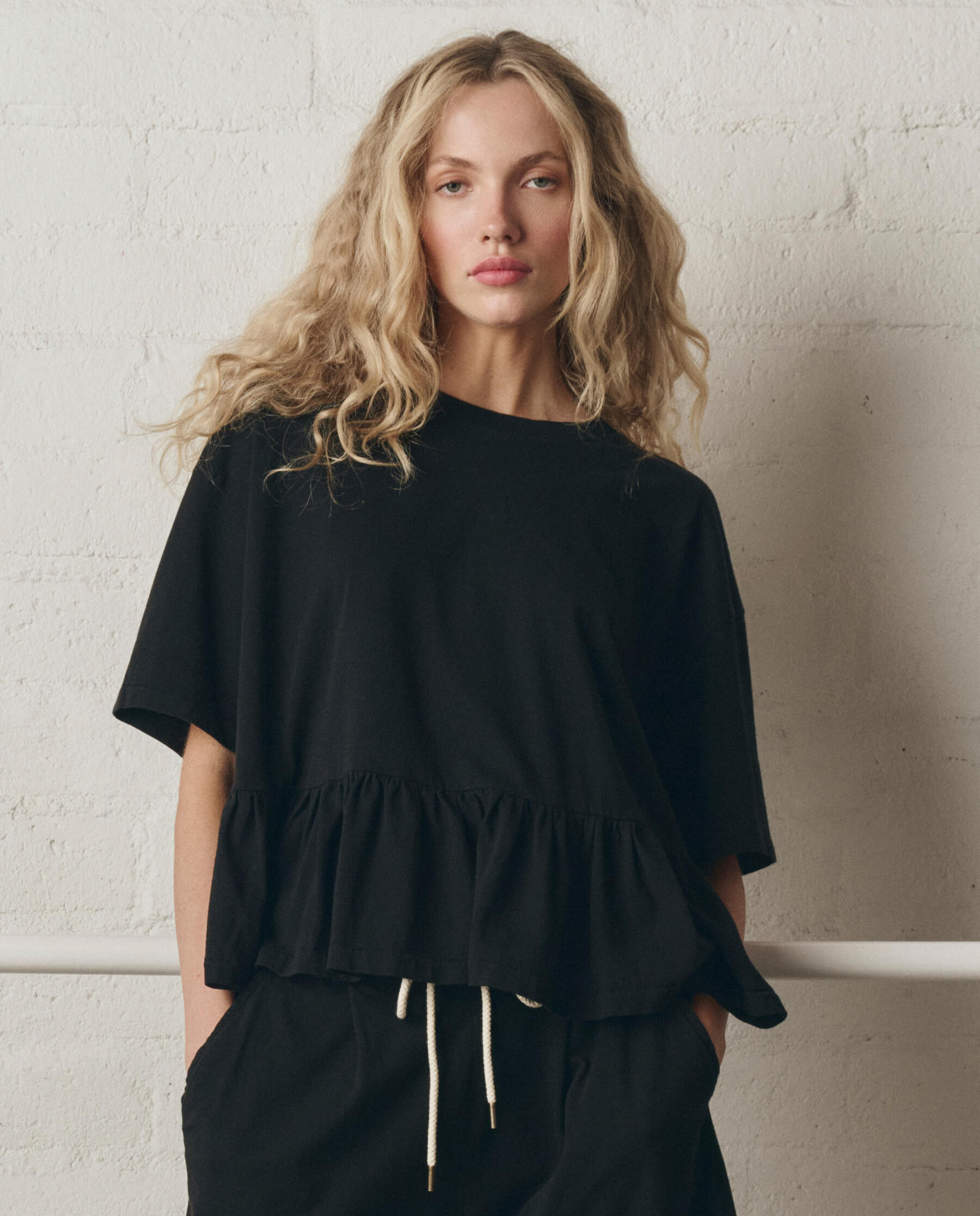 The Oversized Ruffle Peplum Tee. -- True Black – The Great.