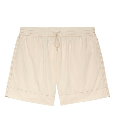 The Rover Short from THE GREAT. SP25 TGO offers a casual style with an elastic waistband and drawstring for comfort, available in a cream color.
