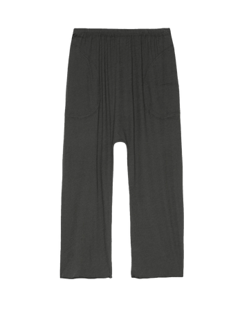 The Lounge Crop in Washed Black by THE GREAT. HOL 24 SLEEP features dark gray wide-leg design, an elastic waistband, and front pockets, displayed against a white background.