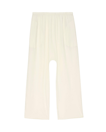 The Lounge Crop in Washed White by THE GREAT. HOL 24 SLEEP features wide-legged, light-colored lounge pants with an elastic waistband, crafted from super soft jersey, shown laid flat against a plain background.