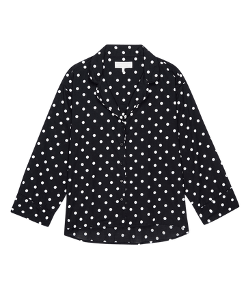 The Pajama Shirt by THE GREAT. PS25 SLEEP is a black long-sleeve pajama top with white polka dots, featuring a collar and button-down front.