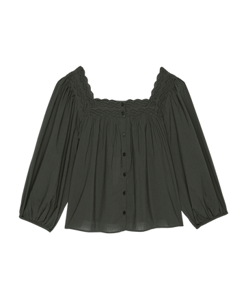 The Eyelet Button Sleep Top in black by THE GREAT. PS25 SLEEP is a dark green, long-sleeved blouse made from soft cotton voile, adorned with Victorian-inspired lace trim and eyelet buttons down the front.