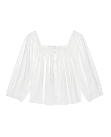 The Eyelet Button Sleep Top from THE GREAT. PS25 SLEEP, in True White, is a cotton voile blouse with a square lace neckline, Victorian-inspired eyelet lace trim, and front buttons.