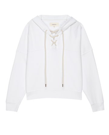 The Lace Up Hoodie by THE GREAT. PS25 FRENCH TERRY KNITS in True White boasts a fashionable lace-up design, stylish front pocket, long sleeves, and adjustable drawstrings.