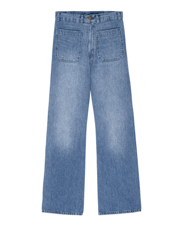The Dock Jean in Marina Wash by THE GREAT. PF24 captures the essence of '70s denim style with its blue wide-leg design and front patch pockets. These high-waisted sailor jeans offer a nostalgic nod to classic fashion on a crisp white background.