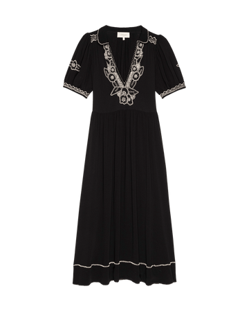 The Elysian Dress from THE GREAT. SP25 D2 showcases black fabric with white floral embroidery, short sleeves, a V-neckline, and a flowy pleated skirt that falls below the knee for an effortlessly elegant look.