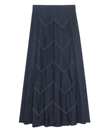 The Beaded Chevron Skirt by THE GREAT. – Black, features a long dark design with white zigzag stitching for a blend of timeless fashion elegance.