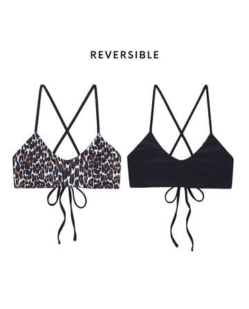 THE GREAT. SP25 SWIM The Reversible Bralette—Leopard and Black—features two reversible bralette bikini tops with crisscross straps, tie backs, a leopard print on one side and solid black on the other for versatile swimwear style.