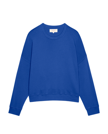The Teammate Sweatshirt by THE GREAT. SP25 KNITS in Bright Cobalt features a long-sleeve, crew neck design with ribbed cuffs, ideal for casual or team wear, displayed on a plain background.