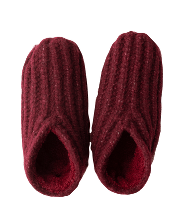 A cozy pair of The Bootie Slipper in Rhubarb, featuring a knitted design and plush sherpa lining, viewed from above—perfect for a thoughtful holiday gift by THE GREAT. HOL 24 SLEEP.