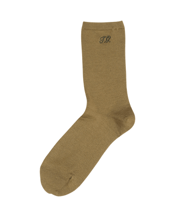 A single Monogrammed Trouser Sock in Golden Ochre by THE GREAT. F25 D1 ACCESSORIES, made of mercerized cotton, featuring "TP" initials near the top.