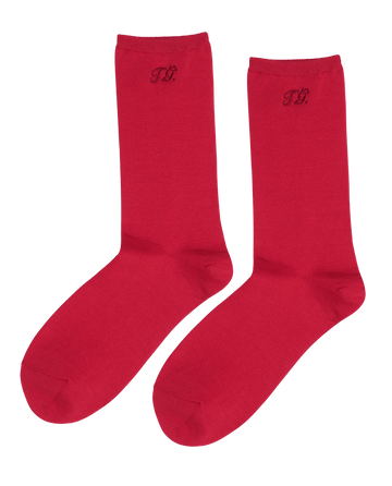 The Monogrammed Trouser Sock in Poppy Red by THE GREAT. F25 D1 ACCESSORIES features a "T.R." monogram near the top and is crafted from soft mercerized cotton.