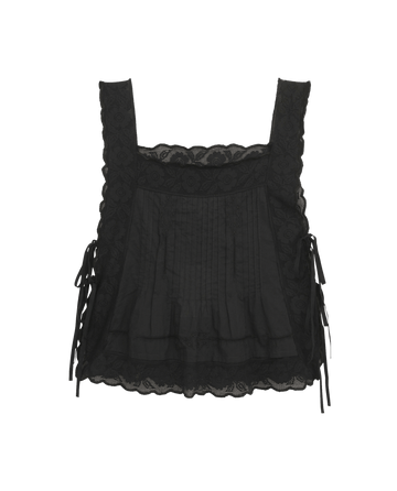 The Attic Lace Cami by THE GREAT. SU25 features a black square neckline, lace details, side ribbon ties, and a scalloped hem—an elegant addition to any wardrobe.