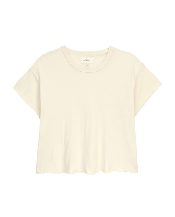 The Crop Tee by THE GREAT. CORE KNITS is a super soft, solid washed white T-shirt featuring short sleeves and a round neckline.