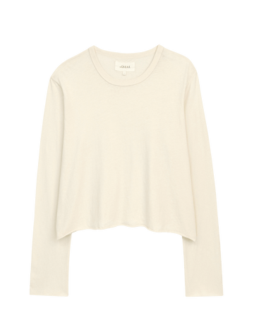 The Long Sleeve Crop Tee in Washed White by THE GREAT. CORE KNITS features a simple beige design with a round neckline, ideal for layering, shown on a white background.