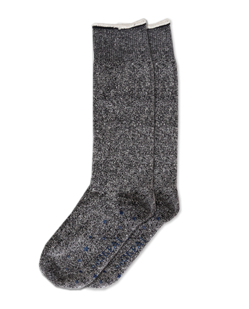 A gray speckled pair of THE GREAT.'s "The Sweatshirt Sock" in black, featuring a white trim, is presented against a black backdrop, highlighting premium quality in apparel.