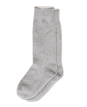 The Sweatshirt Sock -- Heather Grey by THE GREAT. SP25 is elegantly displayed against a black backdrop, evoking the cozy comfort of your favorite sweatshirt.