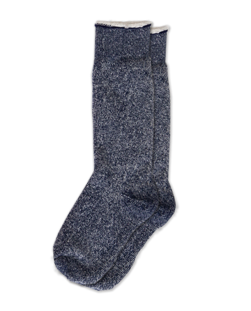 The Sweatshirt Sock by THE GREAT. SP25, in navy blue, exemplifies cozy fashion with its blue and gray marled wool against a black backdrop.