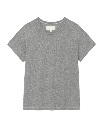 A heather grey, short-sleeved T-shirt from THE GREAT. CORE KNITS, known as The Boxy Crew, laid flat and reminiscent of classic vintage tees made in the U.S.A.