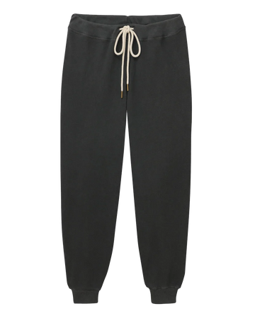 A pair of The Cropped Sweatpant in Washed Black by THE GREAT. CORE KNITS, featuring a beige drawstring waistband and ribbed cuffs at the ankles, reminiscent of vintage gym pants.